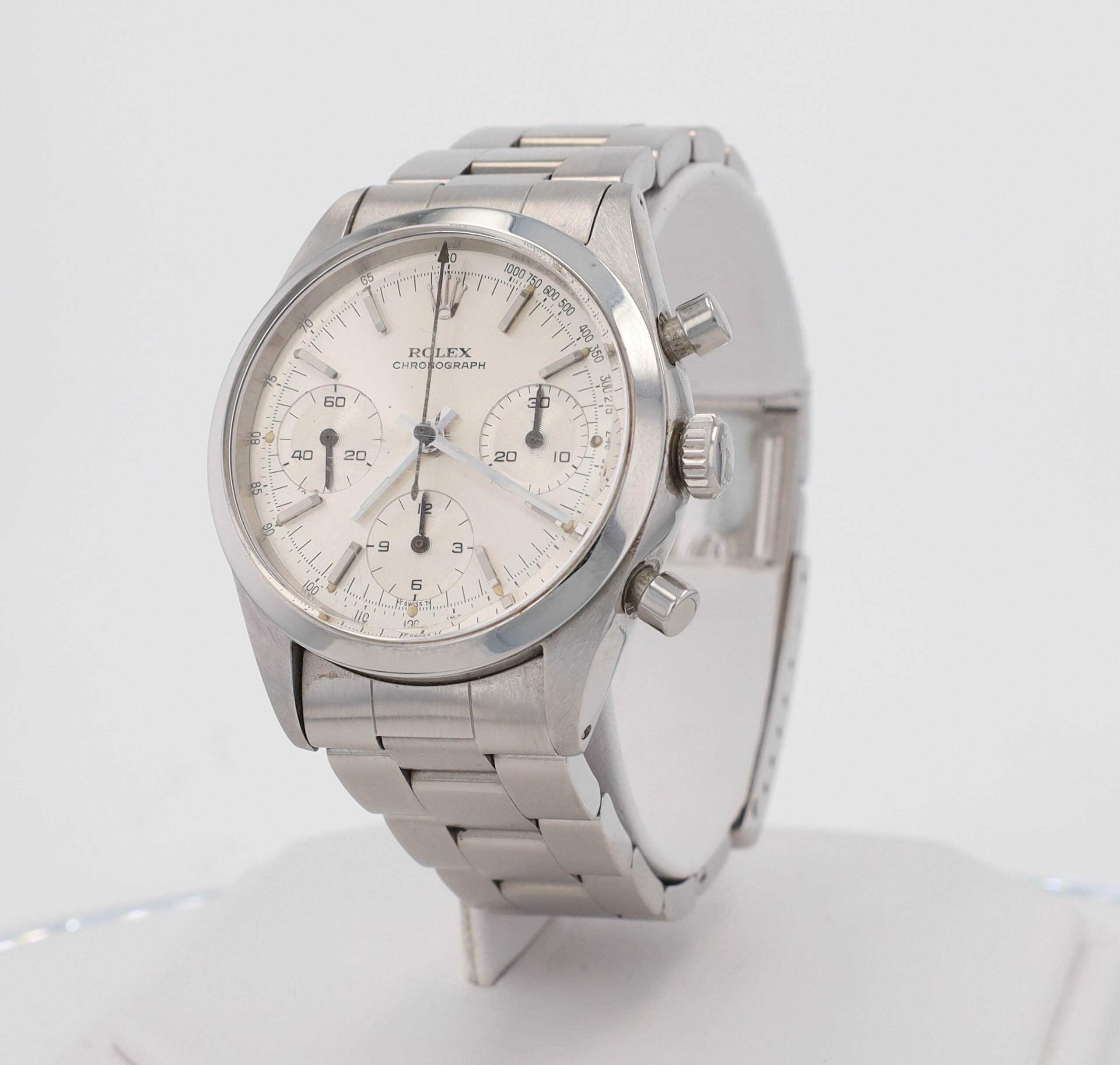 Close-up of a stainless steel Rolex chronograph watch with a white dial and metal bracelet