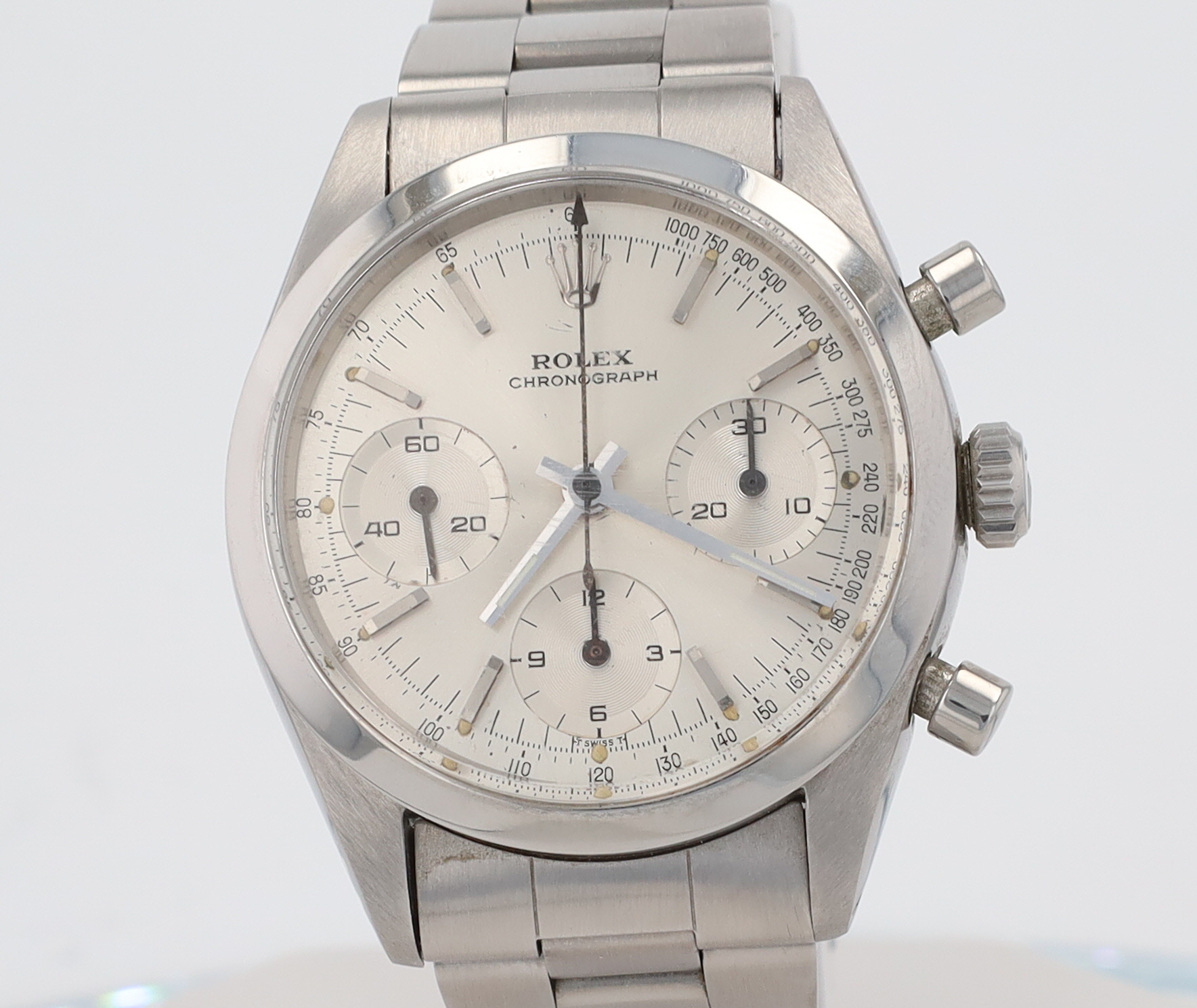 Close-up of a stainless steel Rolex chronograph watch dial with three subdials and a tachymeter bezel