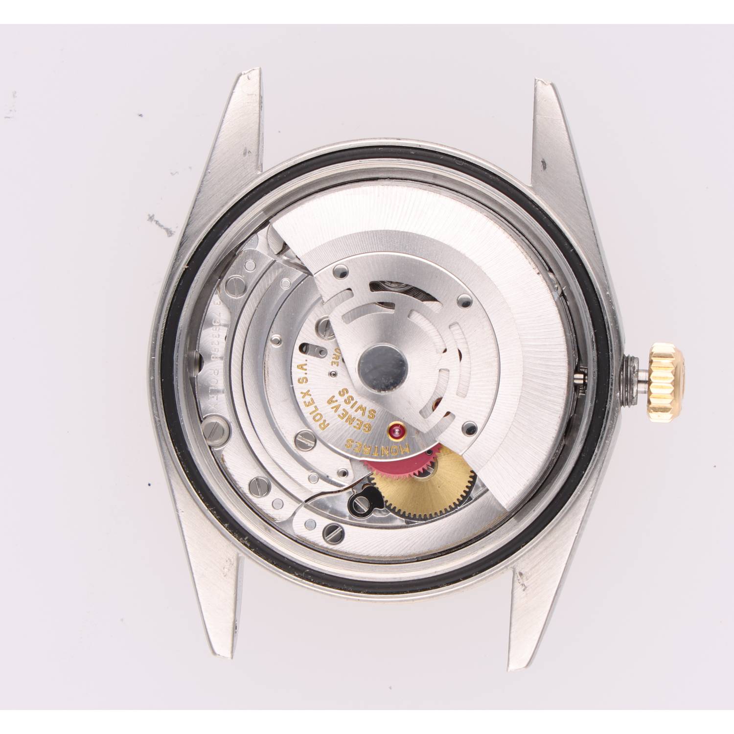 Automatic wristwatch movement with rotor and gears visible through the caseback; crown on the right.