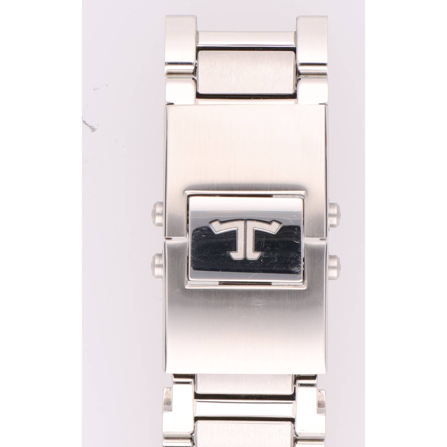 Close-up of a silver stainless steel watch bracelet clasp with a stylized double-T logo on the lock.