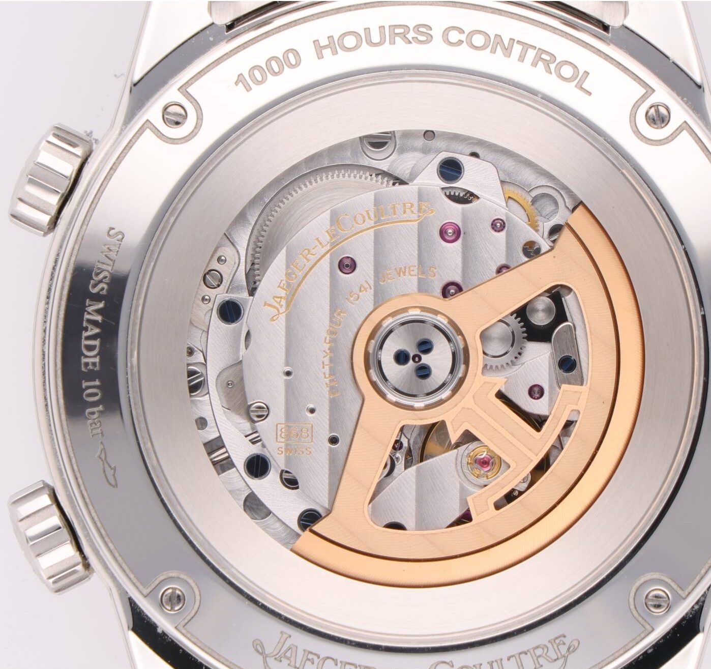 Close-up of a Jaeger-LeCoultre automatic movement with rose-gold rotor, visible gears, and the engraving 'Jaeger-LeCoultre' and '1000 HOURS CONTROL' on the caseback.