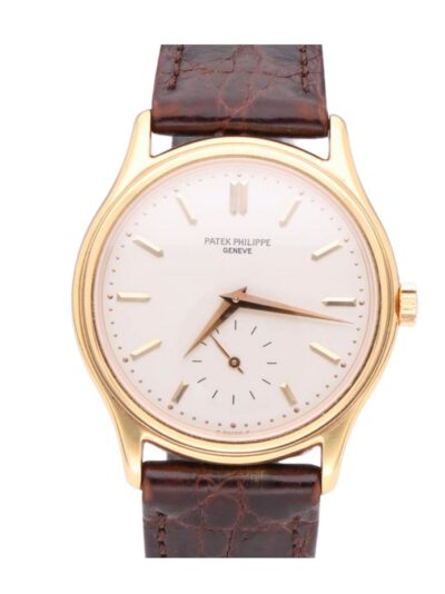 Gold Patek Philippe wristwatch with white dial and brown leather strap, close-up view.