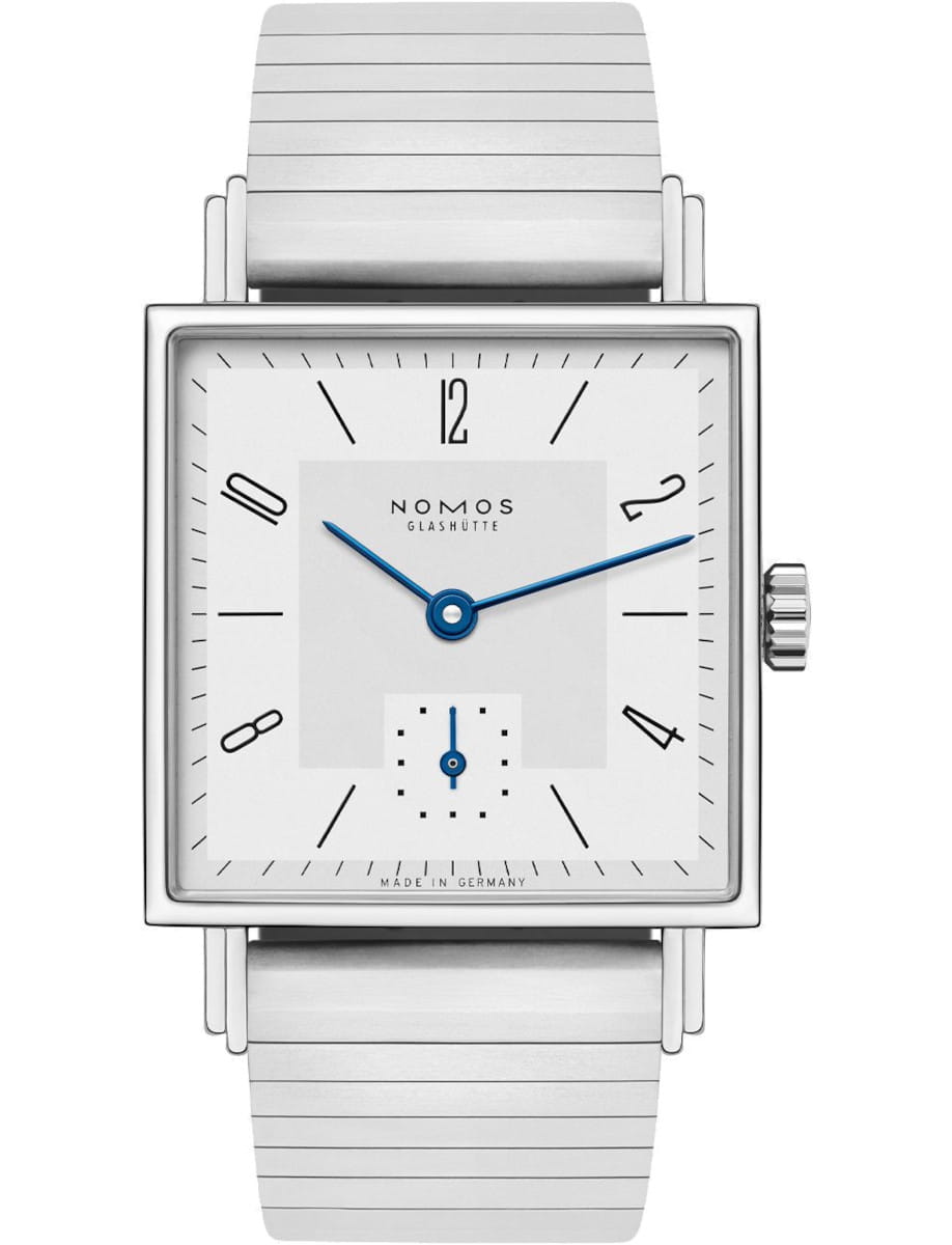 Square stainless steel wristwatch with blue hands, Nomos Glashütte branding, and a silver bracelet, Made in Germany.