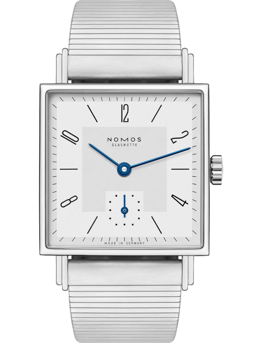 Square Nomos Glashütte wristwatch with a brushed silver metal band and blue hands on a white dial, minimalist design.