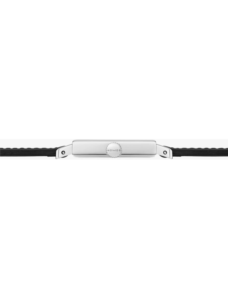 Silver Nomos watch crown with black leather strap, shown in profile on a white background