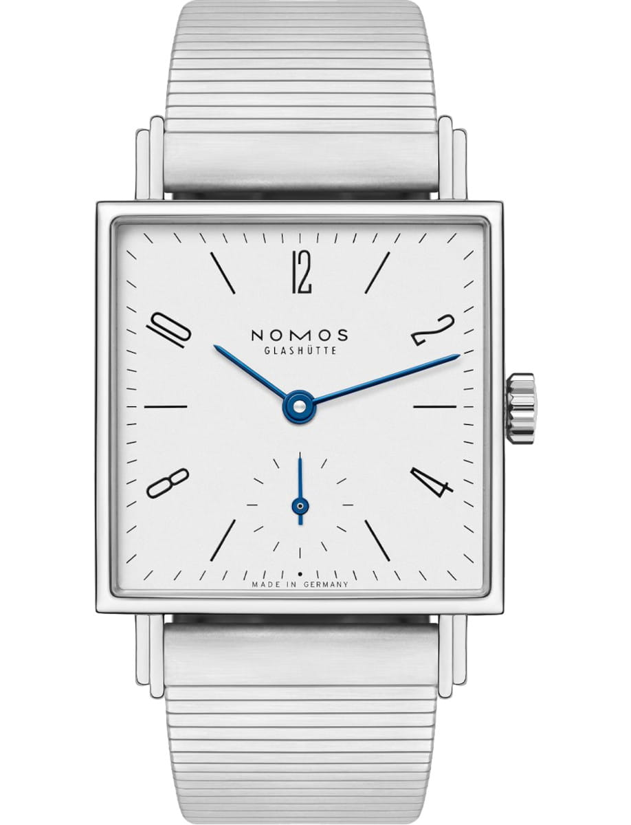 Square-faced Nomos wristwatch with a steel metal band and blue hands, showing time on a white dial.