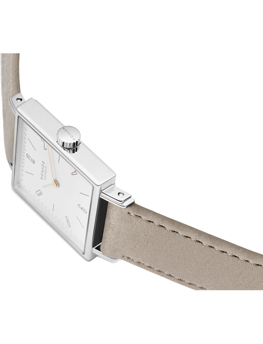 Rectangular silver wristwatch with a white dial and beige leather strap, shown from the side.