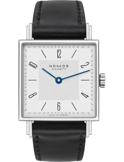 Square-faced wristwatch with white dial, blue hands, and black leather strap (Nomos Glashütte). | Feldmar Watch Co. Square-faced wristwatch with white dial, blue hands, and black leather strap (Nomos Glashütte).