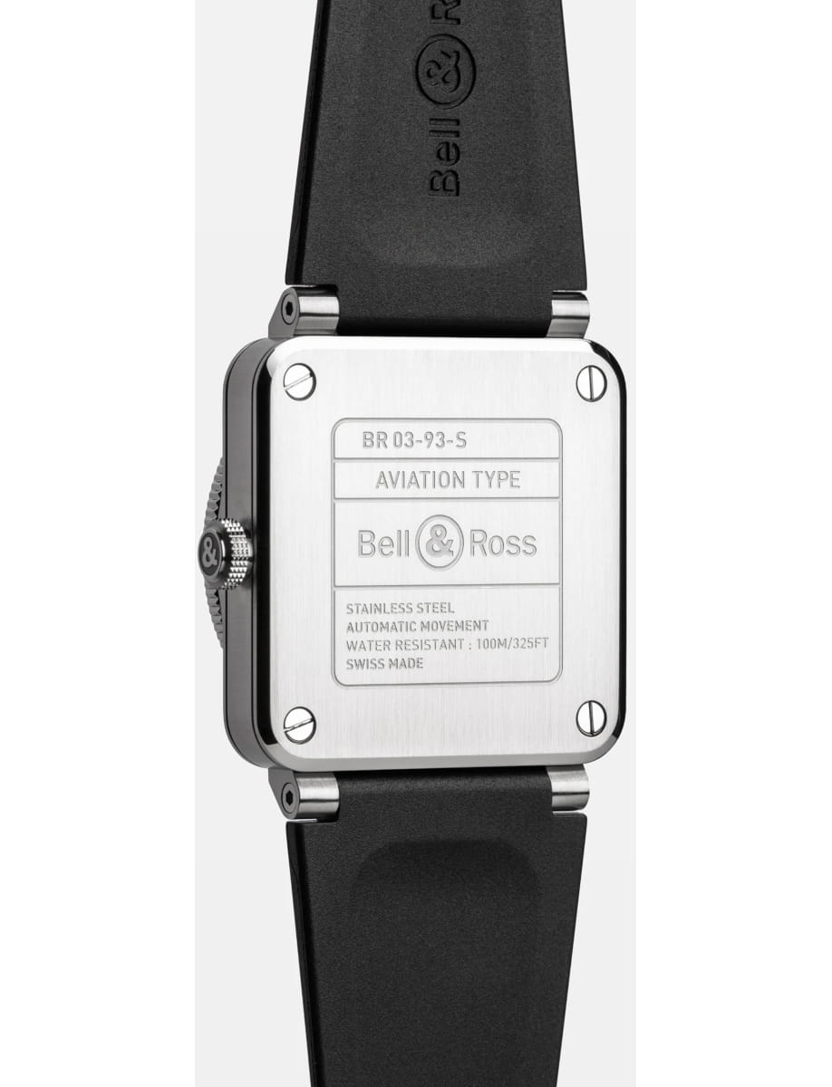 Back of a Bell & Ross watch: brushed stainless steel case back with engraved 'AVIATION TYPE' and logos, attached to a black rubber strap.