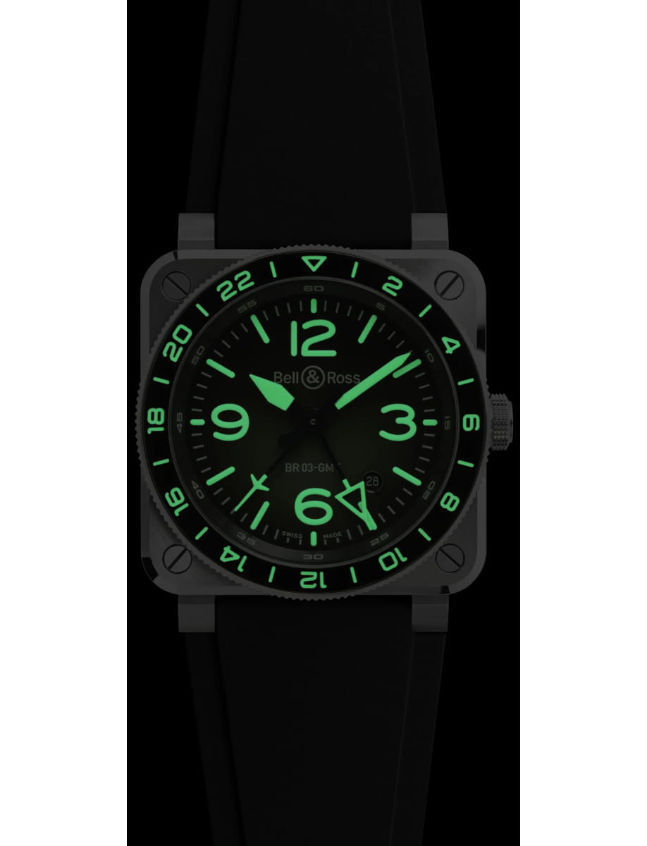 Bell & Ross square-faced watch with glowing green numerals and hands on a black dial and strap.