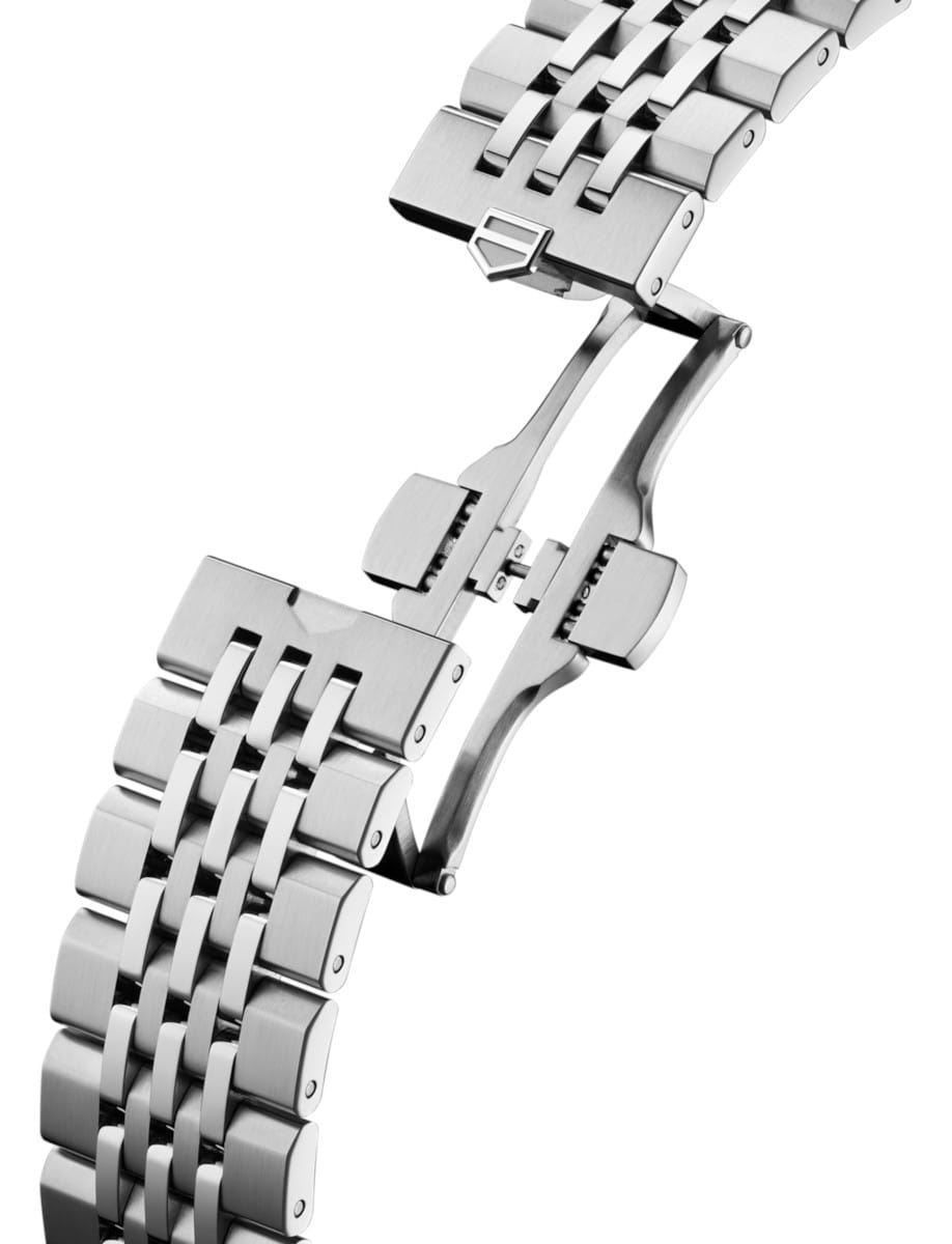 Close-up of a stainless steel watch bracelet with a deployment clasp.