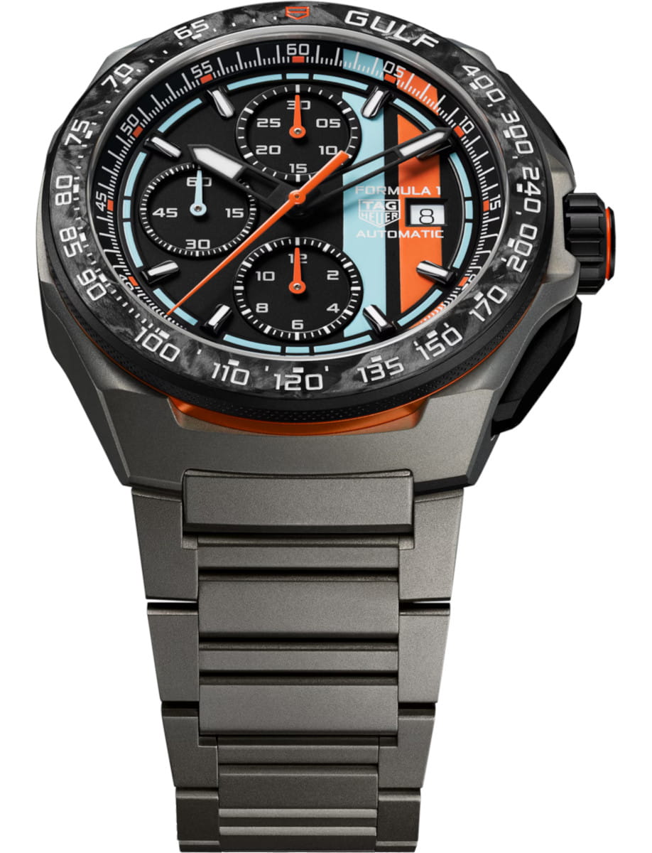 TAG Heuer Formula 1 automatic chronograph with black dial, orange hands, blue accents, date window, and titanium bracelet.