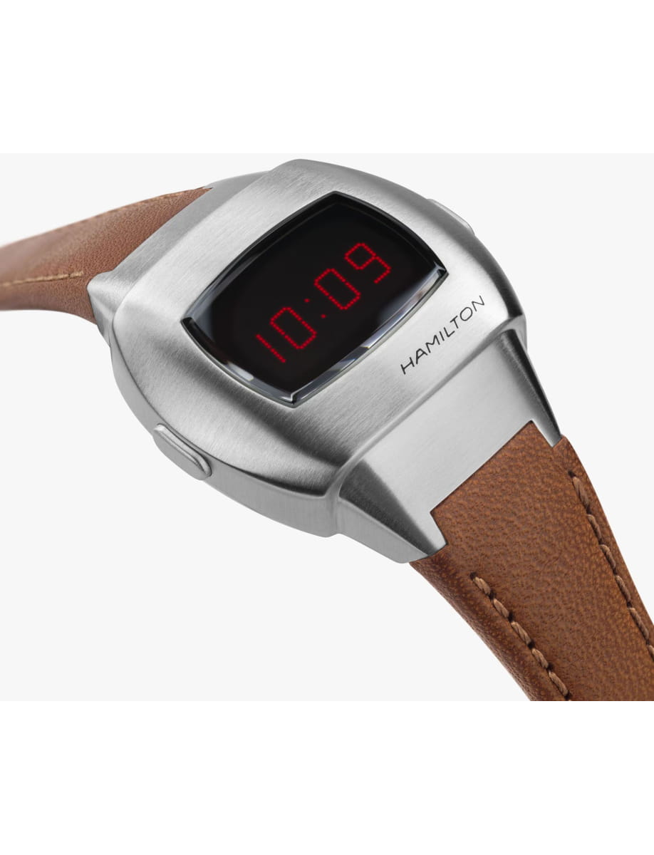 Hamilton digital wristwatch with a brushed silver case and brown leather strap, displaying 10:09 on the face