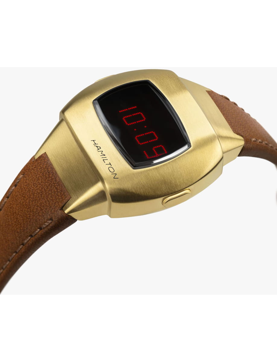 Hamilton digital wristwatch with a brushed yellow gold case and brown leather strap, displaying 10:09 on the face
