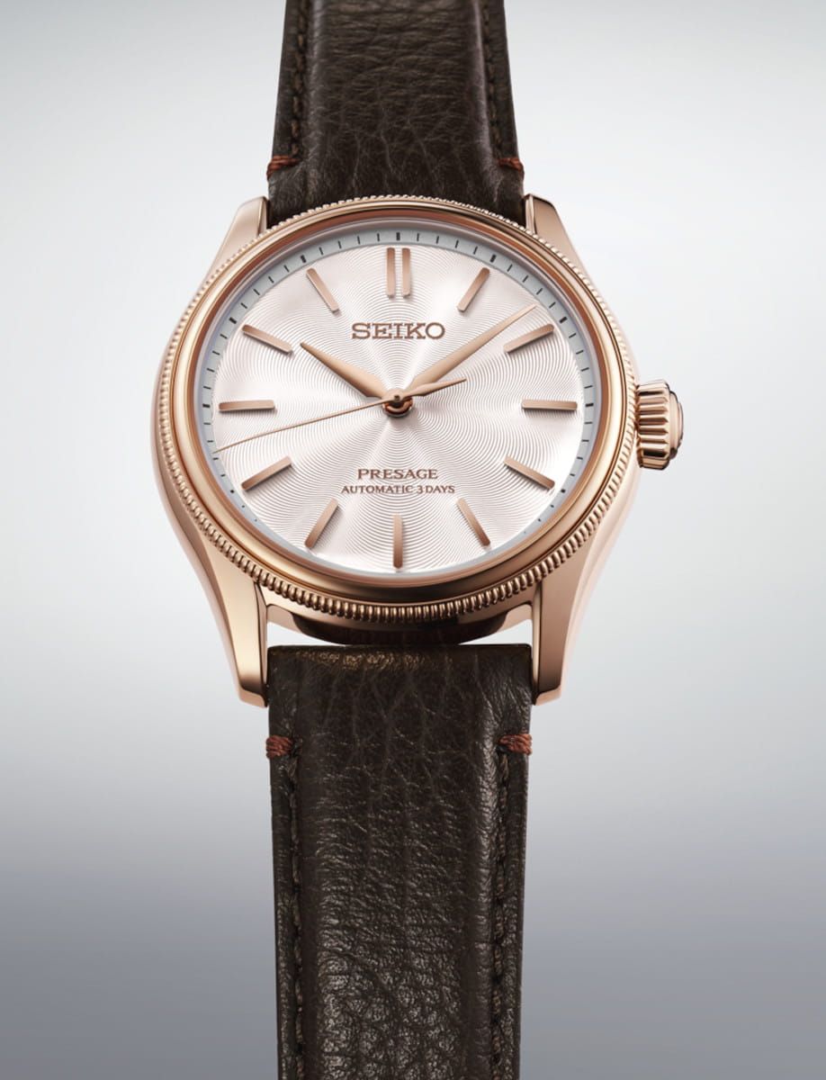 Rose-gold colored stainless steel Seiko Presage automatic wristwatch with a textured white dial and brown leather strap