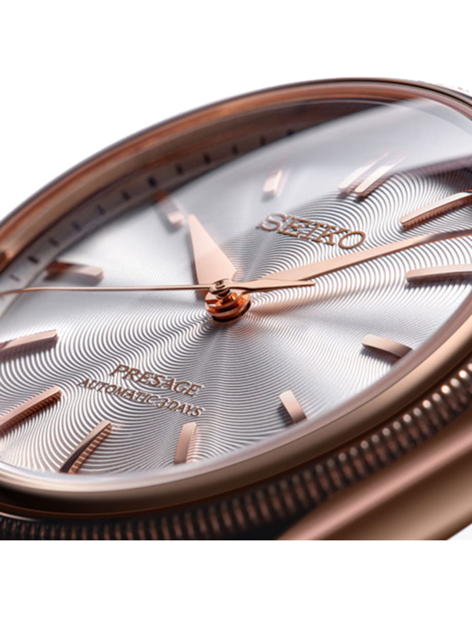 Close-up of a rose-gold colored stainless steel Seiko Presage automatic watch dial with a rose-gold color hands and markers.
