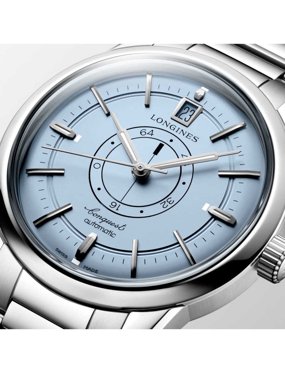Close view of Longines Conquest Heritage Central Power Reserve wristwatch with stainless steel case and bracelet, and light blue opaline dial.