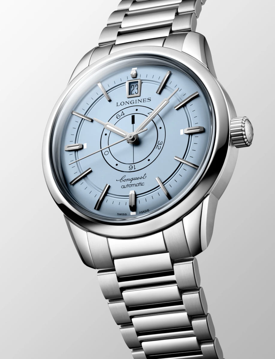 Side view of Longines Conquest Heritage Central Power Reserve wristwatch with stainless steel case and bracelet, and light blue opaline dial.