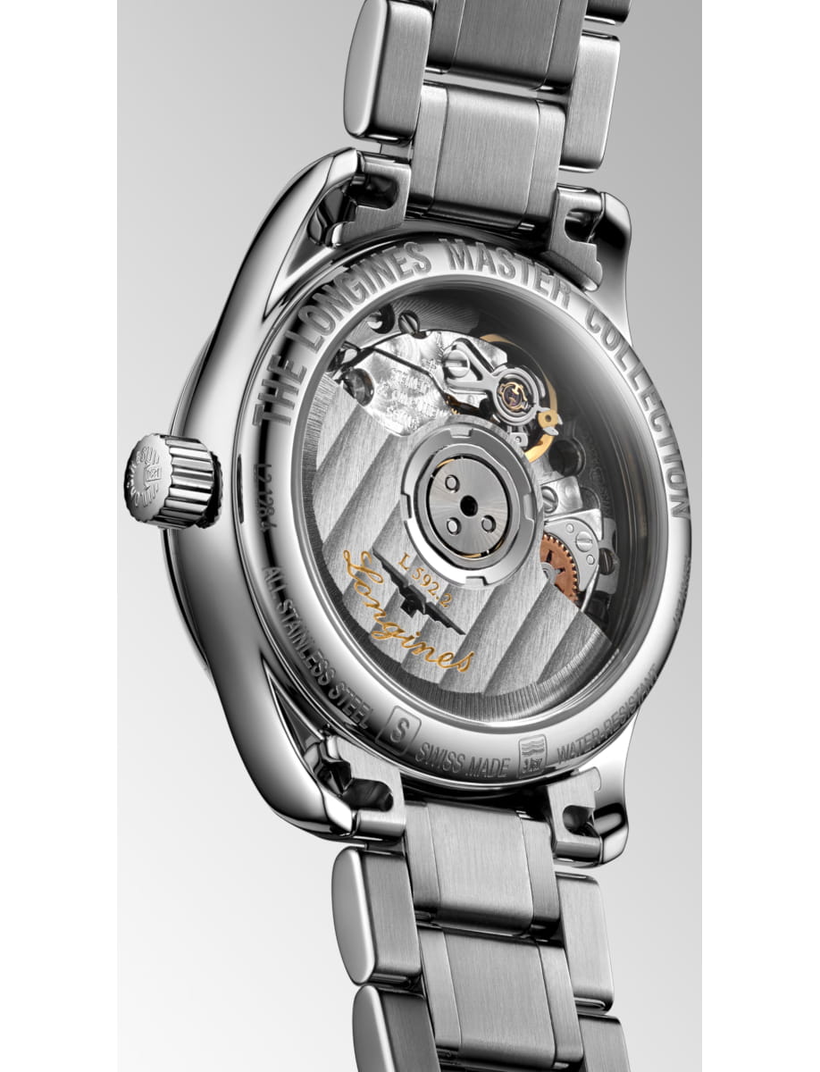 Stainless steel wristwatch with a transparent back revealing the mechanical movement and gears.