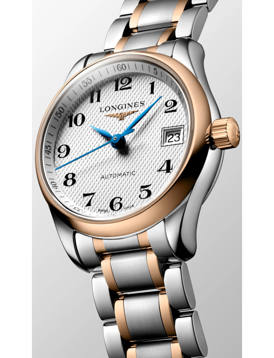 Close-up of a two-tone Longines automatic wristwatch with a white dial, blue hands, and a date window set in a stainless steel and rose-gold bracelet.