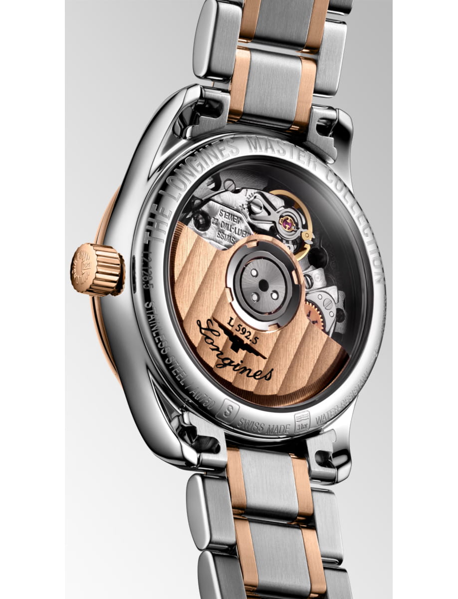 Two-tone wristwatch with a transparent case back showing the intricate automatic movement in rose gold and steel links.