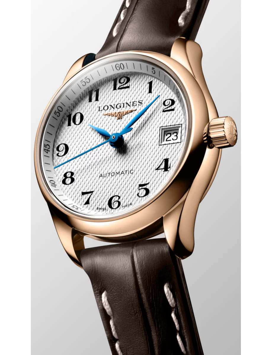 Side view of Longines wristwatch with rose gold case and alligator leather strap