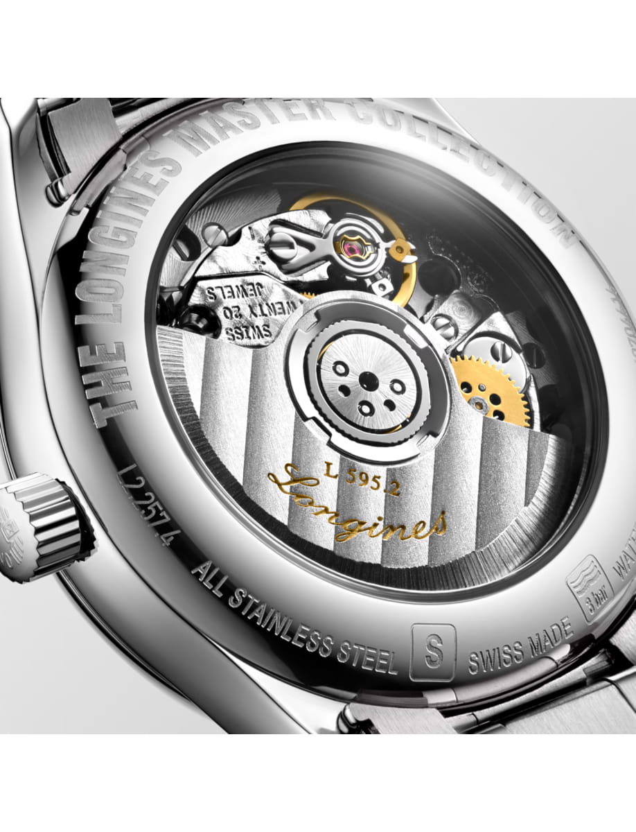 Close-up of a stainless steel watch caseback revealing the intricate mechanical movement with gears and engravings like 'Longines' and 'All Stainless Steel'.