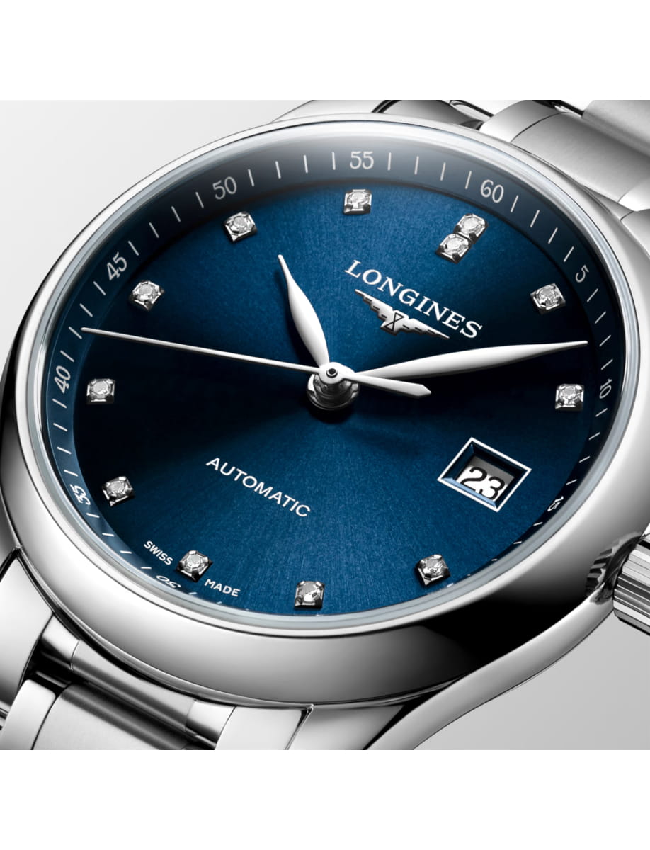 Close-up of a Longines automatic wristwatch with a blue dial, diamond hour markers, and a date window