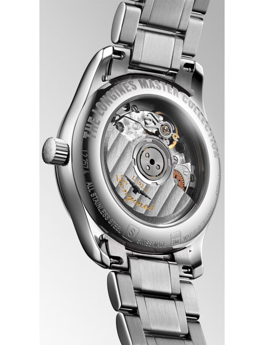 Close-up of a stainless steel wristwatch showing its transparent case back with visible mechanical movement, from Longines Master Collection.