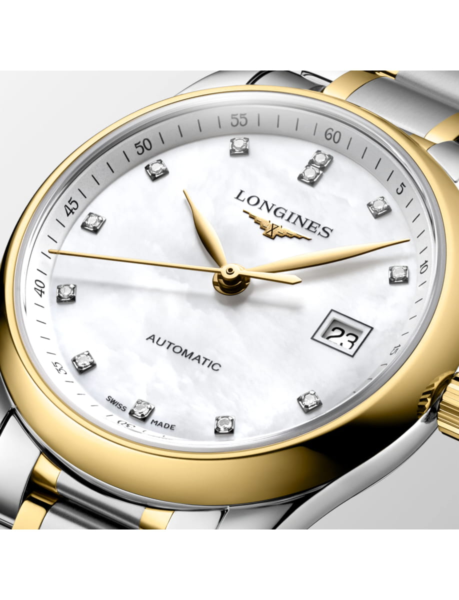 Close-up of a two-tone gold and stainless steel Longines automatic wristwatch with diamond hour markers and a date window