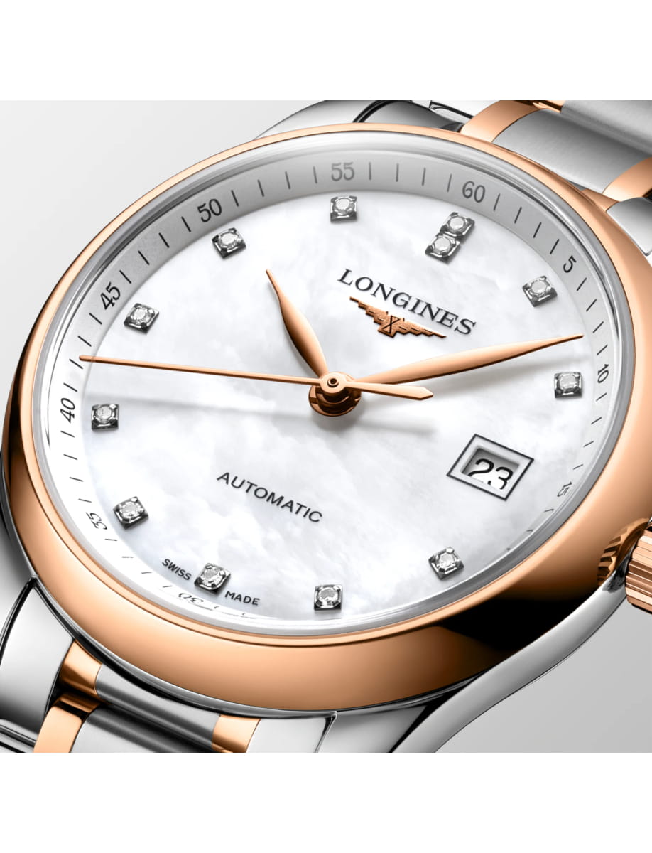 Longines automatic wristwatch with rose-gold bezel, diamond hour markers, and date window at 3 o'clock on a mother-of-pearl dial.