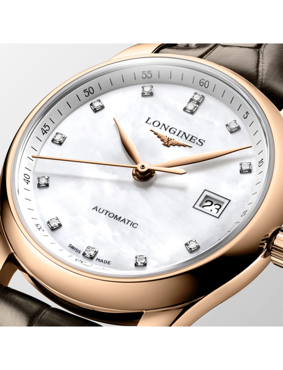 Longines watch with a white mother-of-pearl dial, diamond hour markers, and gold case; date display at 3 o'clock, leather strap featured.