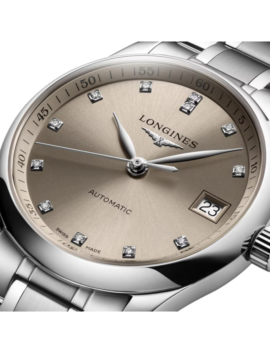 Close-up of a silver Longines automatic wristwatch with diamond hour markers and a date window showing 23.