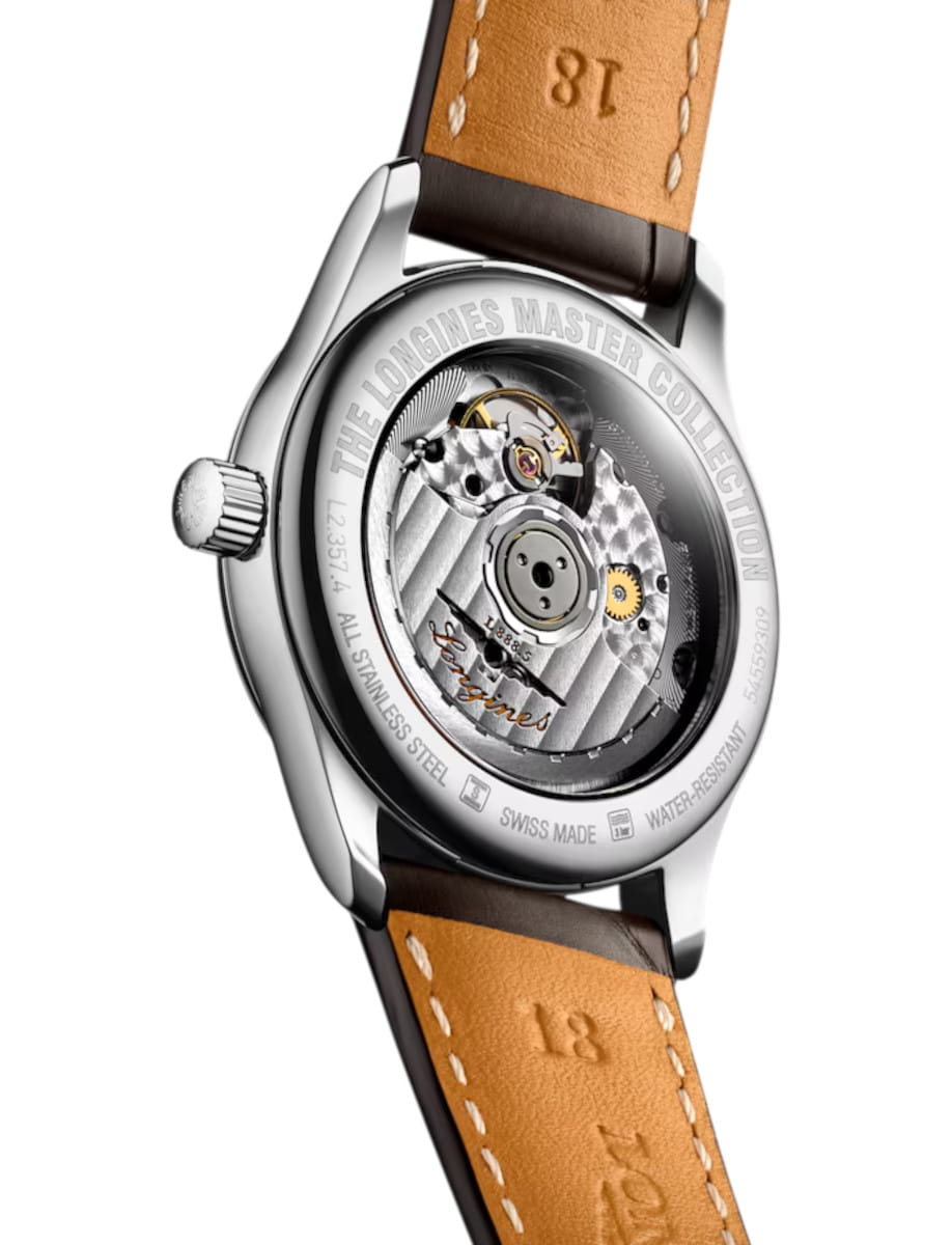 Back view of a Longines Master Collection wristwatch with a transparent caseback showing the mechanical movement and a tan leather strap.
