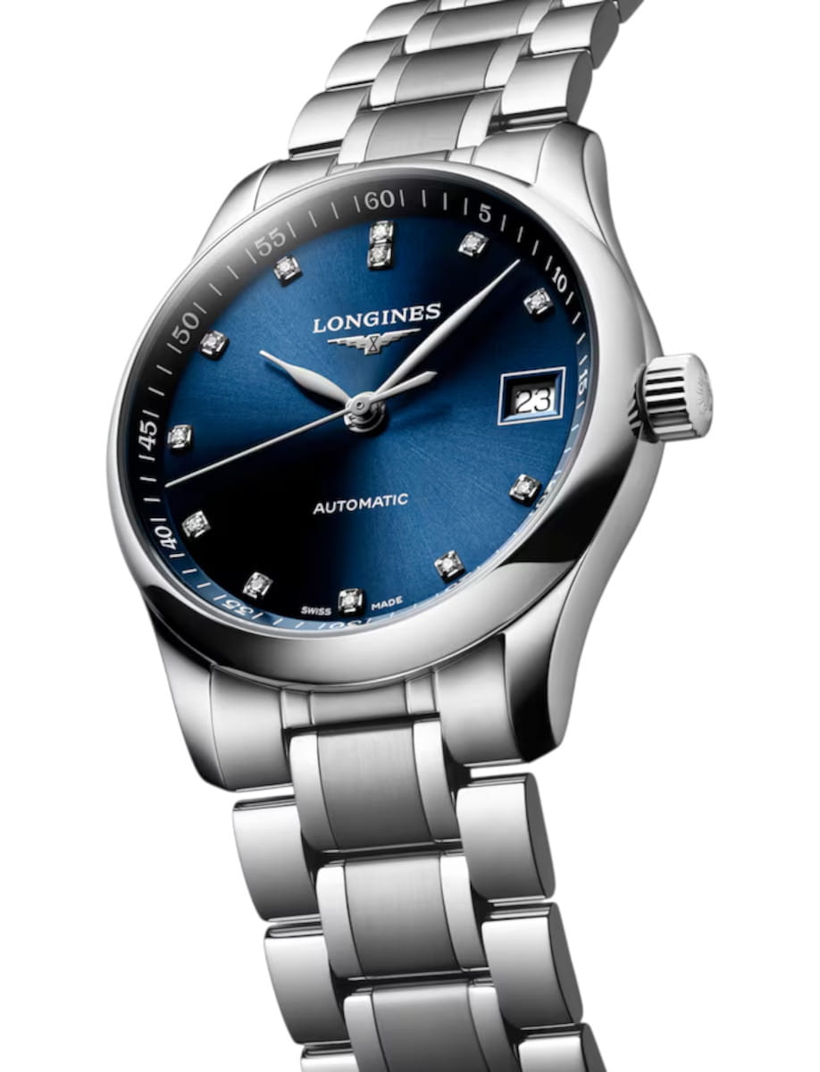 Longines automatic wristwatch with a blue dial, diamond hour markers, and a stainless steel bracelet with a date window at 3 o'clock.