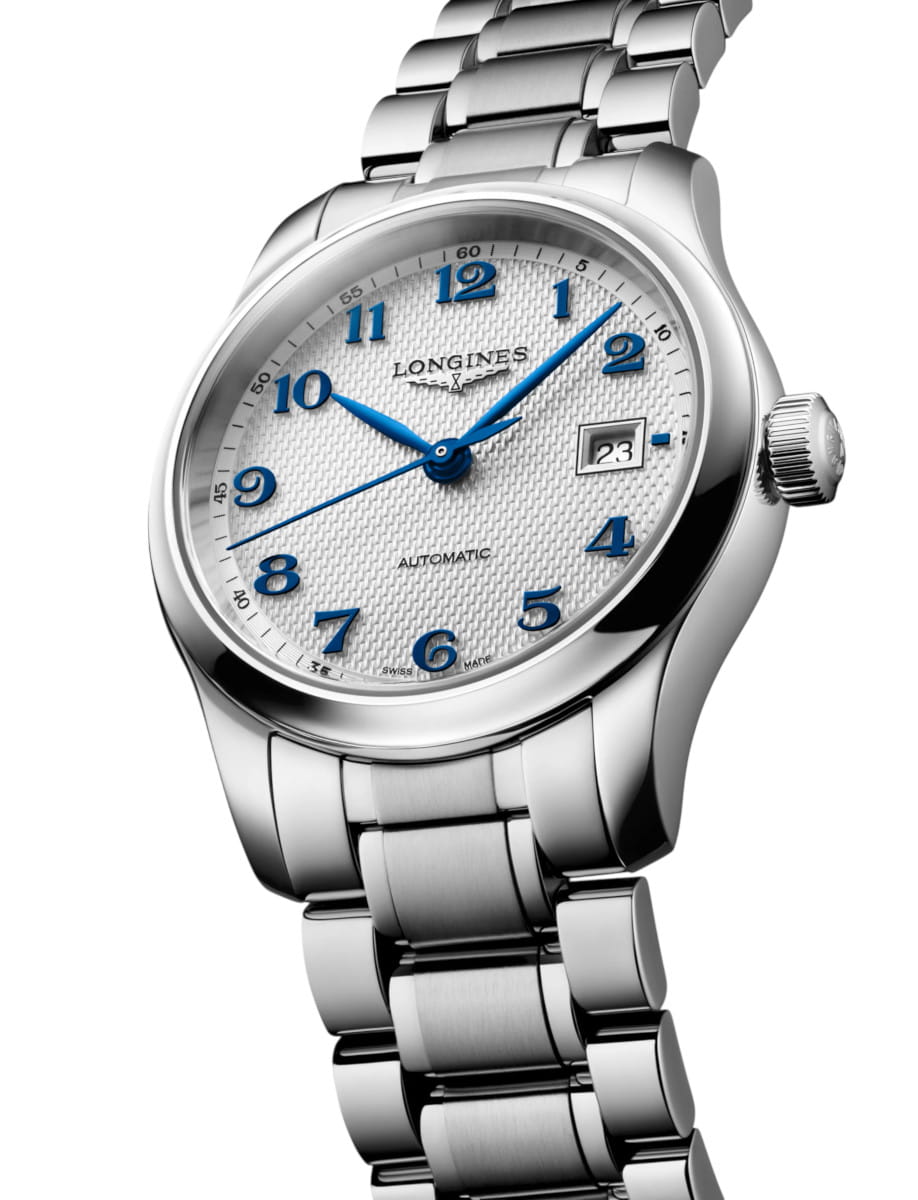 Longines automatic wristwatch with a stainless steel band, blue numerals, silver dial, and a date window at 3 o'clock.