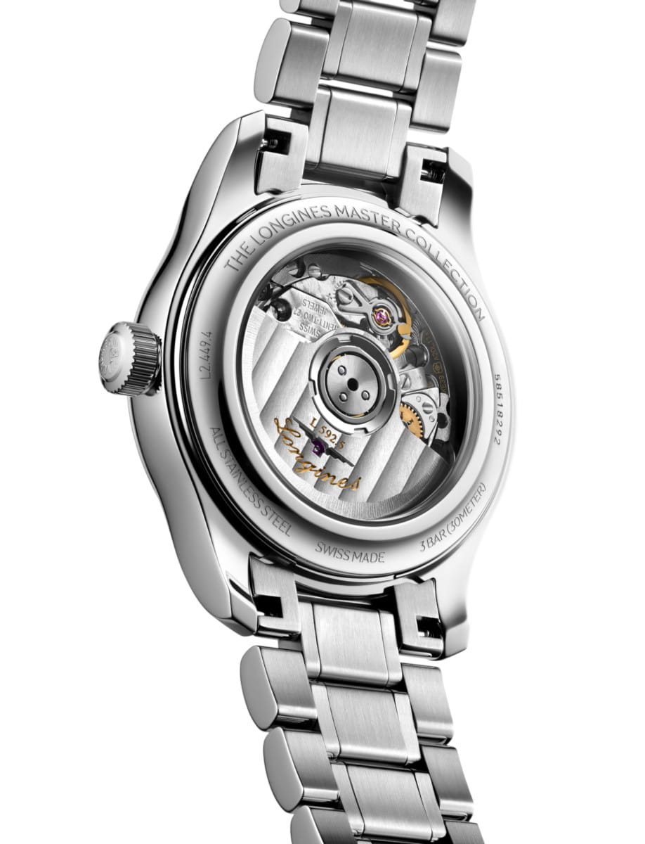 Back of a stainless steel wristwatch with a transparent caseback showing the mechanical movement and 'Longines Master Collection' engraving around the edge.