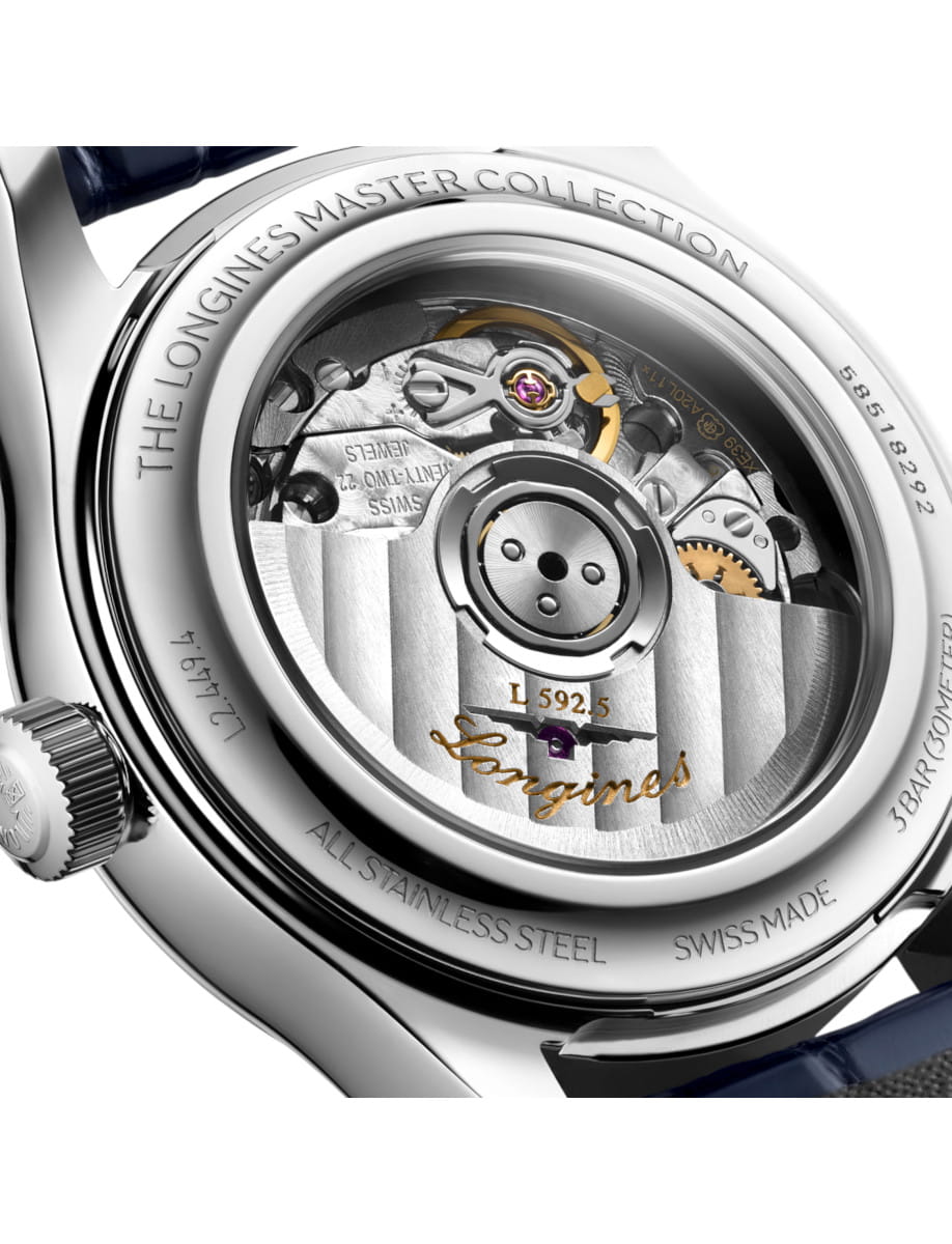 Close-up of the stainless steel case back of a Longines wristwatch, showing the intricate mechanical movement through a transparent window.