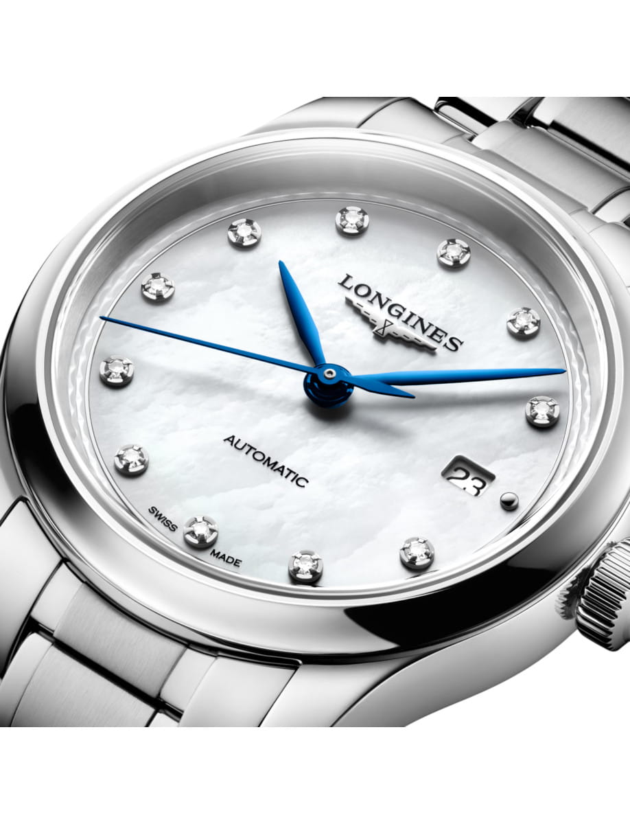 Close-up of a silver Longines automatic wristwatch with blue hands and diamond hour markers.