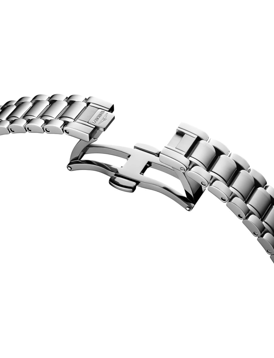 Close-up of a stainless steel watch band with a deployment (fold-over) clasp