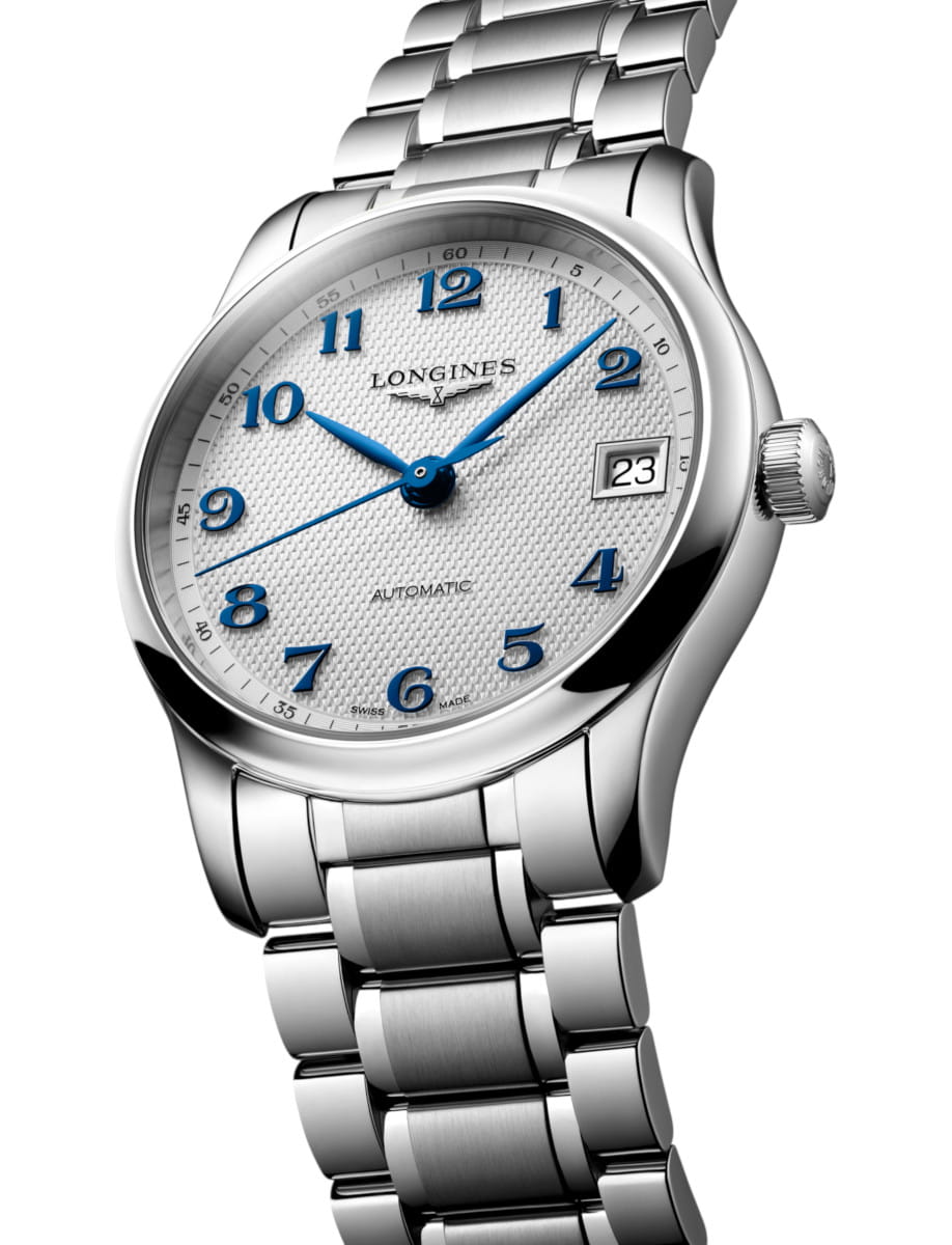 Longines wristwatch with a stainless steel band, Silver barleycorn dial, blue numerals, and a date window showing 23 (automatic).