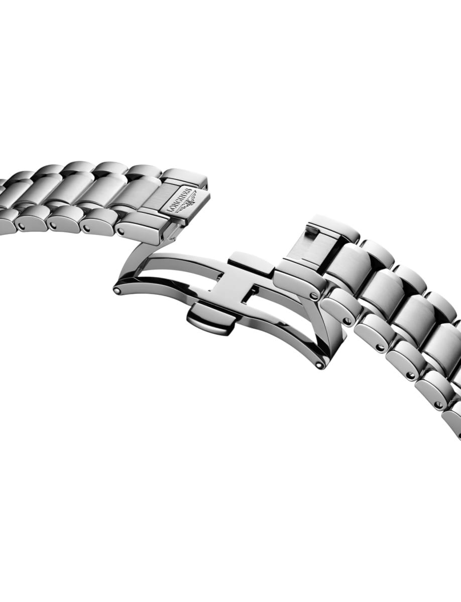 Close-up of a stainless steel watch bracelet with a deployment clasp, partially open.