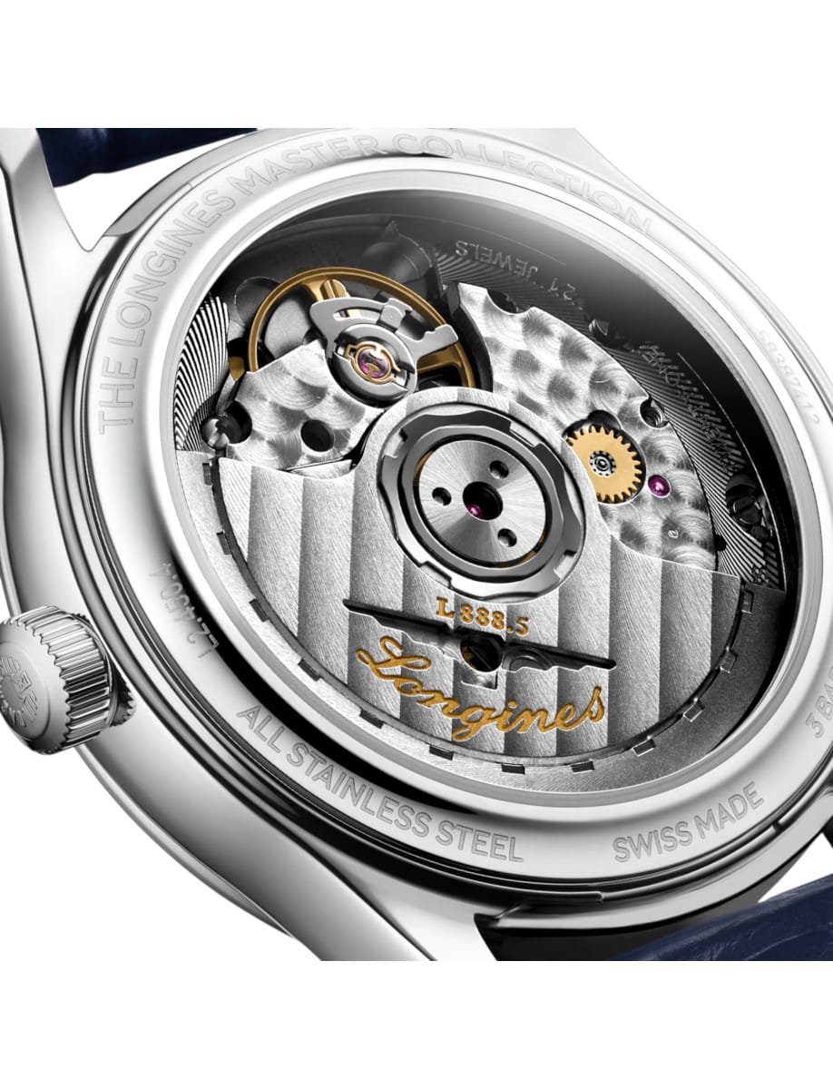 Back case of a stainless steel Longines watch, exposing the intricate mechanical movement with a gold balance wheel and engraved Longines logo.