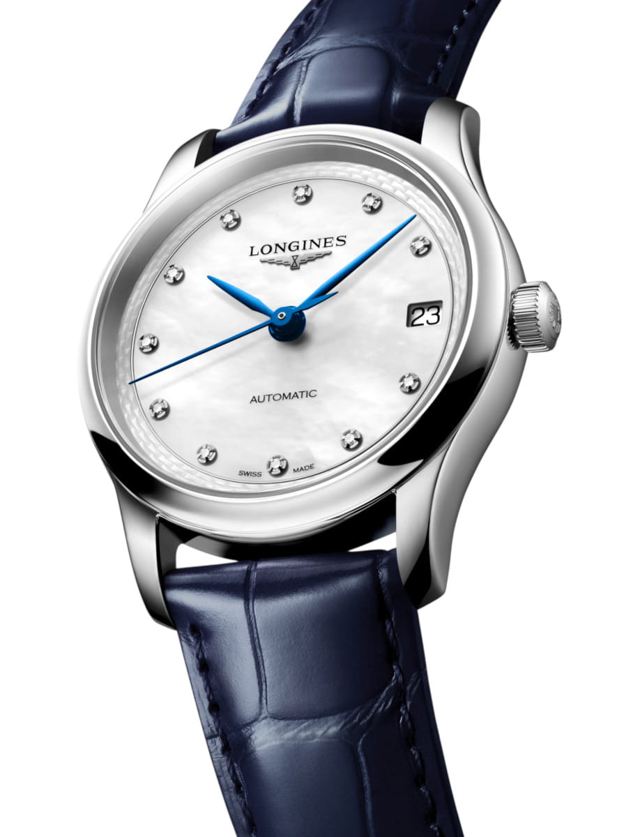 Longines automatic wristwatch with a white mother-of-pearl dial, blue hands, diamond hour markers, date window at 3 o'clock, silver case, and blue leather strap.