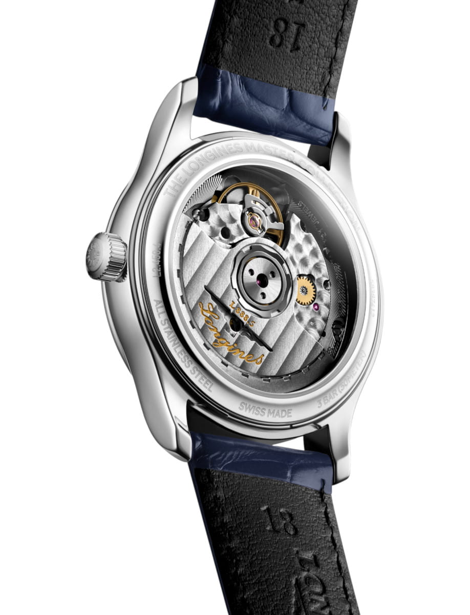 Back view of a stainless steel wristwatch with a transparent case back showing its mechanical movement.