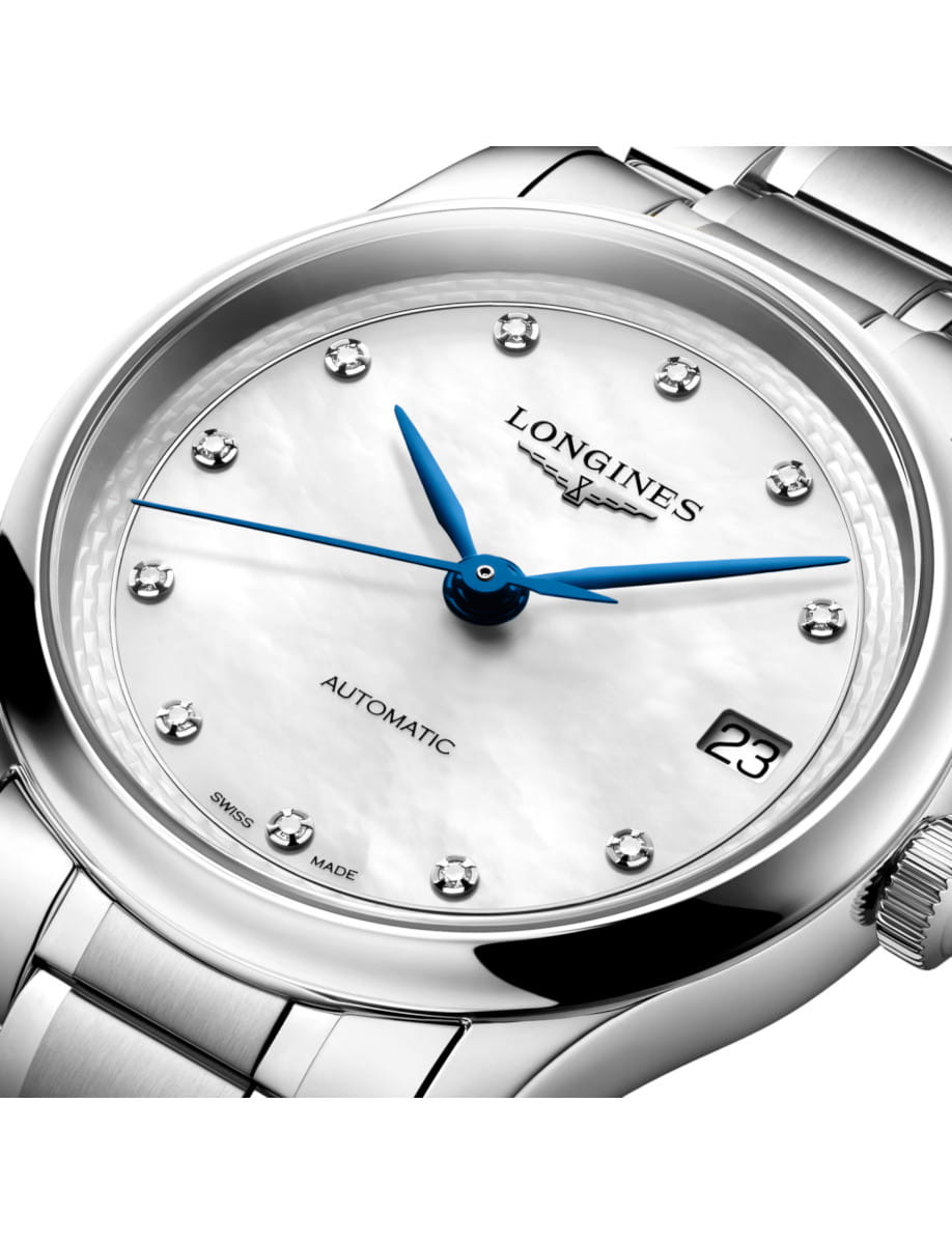 Longines automatic wristwatch with a white mother-of-pearl dial, blue hands, diamond hour markers, and a date window at 3 o'clock.