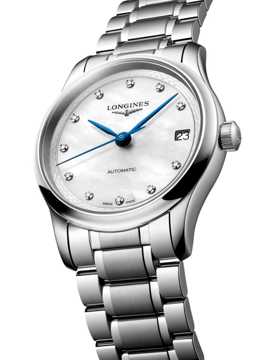 Steel Longines wristwatch with white dial, diamond hour markers, blue hands, and date window showing 23, on a metal bracelet.