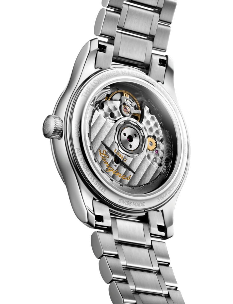 Stainless steel wristwatch with a transparent case back showing the mechanical movement and rotating gears inside the metal dial area, brand visible on rotor.