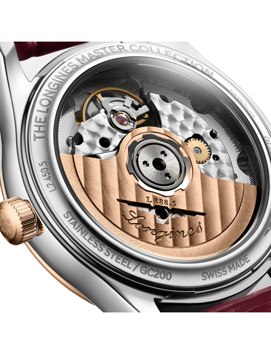 Close-up of a Longines watch movement with a rose-gold rotor, gears, and 'Longines' engravings visible on the back of the case.