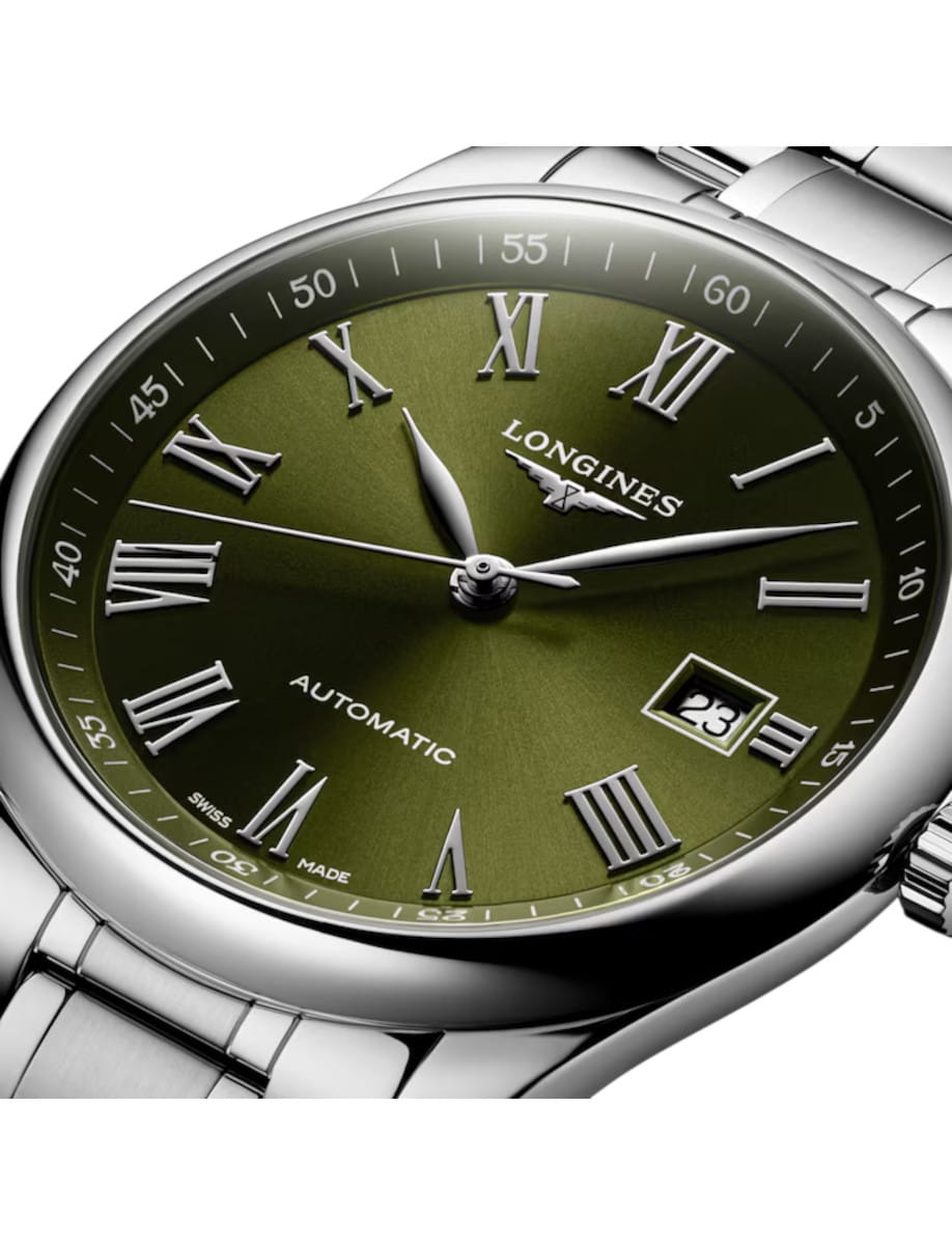 Longines automatic wristwatch with a green dial, Roman numerals, and a date window at 3 o'clock on a stainless steel bracelet